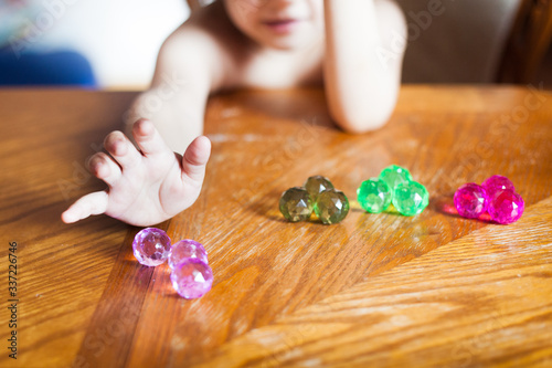 baby develops, counting balls and fine motor skills development of hands, different colors and surfaces, mental development, daughter, child, girl