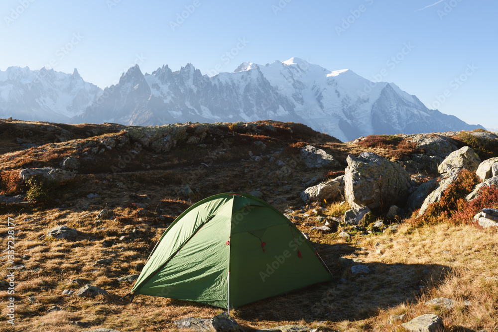 Amazing view on Monte Bianco mountains range with green tent and Monblan on background. Vallon de Berard Nature Preserve, Chamonix, Graian Alps. Landscape photography