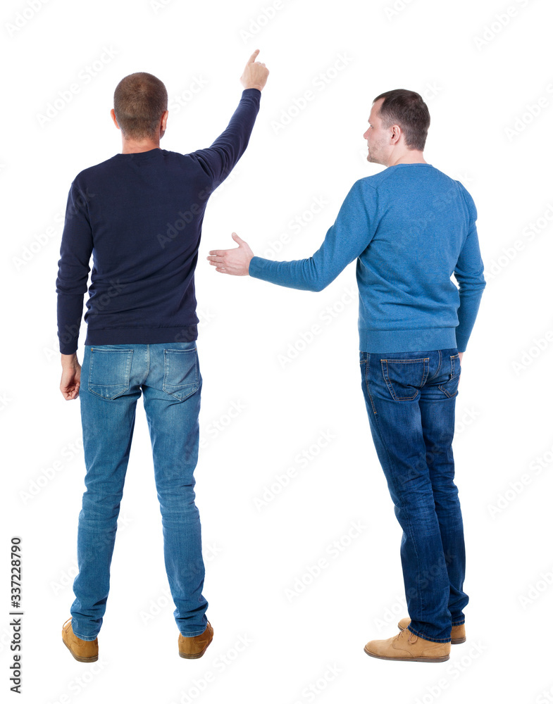 Back view of two man in sweater pointing.