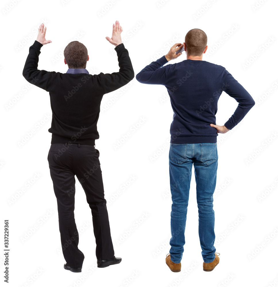 Back view of two man in sweater with mobile phone. Back view of two man in sweater with mobile phone.