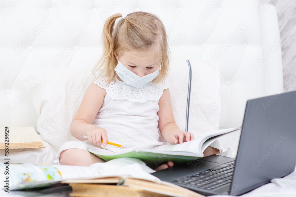 Toddler girl with digital tablet at home. Child watching cartoons. Kid using gadget to communicate with friends or kindergartners. Education and distance learning for kids. Stay at home entertainment Toddler girl with digital tablet at home. Child watching cartoons. Kid using gadget to communicate with friends or kindergartners. Education and distance learning for kids. Stay at home entertainment