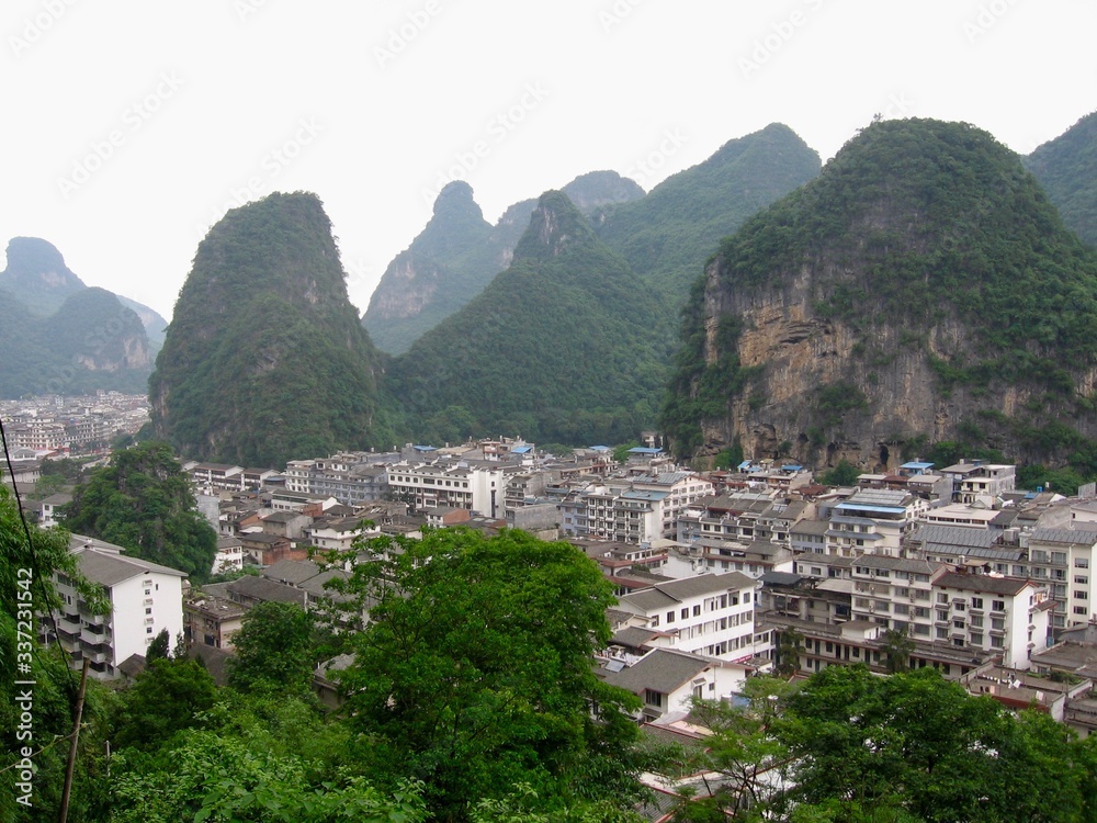 Yangshuo city from the mountain view near Guilin and in China with the misty karst mountains in the background. 