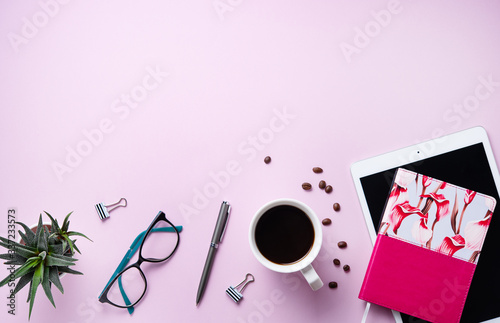 Home work. Business flat lay with cup of coffee, note, pencil, eye glasses, tablet and sicculent on pink background