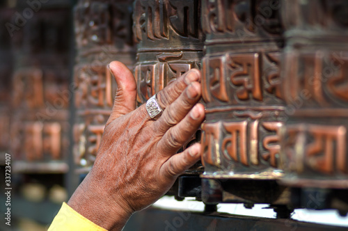 Fotografie Prayer's Wheel with Mantra  Om Mani Padme Hum, an ancient Buddhist mantra