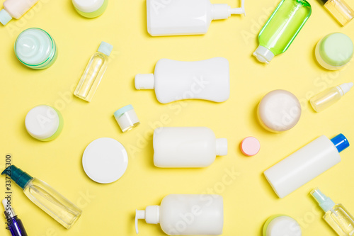 Group of plastic bodycare bottle Flat lay composition with cosmetic products on yellow background empty space for you design. Set of White Cosmetic containers, top view with copy space