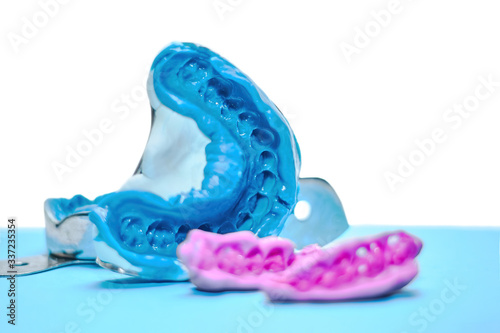 Wallpaper Mural Two dental impressions on a white and blue background. The imprint of the tooth row of high precision and bite registration pieces Torontodigital.ca