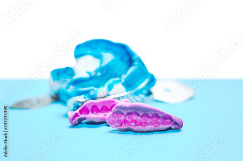 Two dental impressions on a white and blue background. The imprint of the tooth row of high precision and bite registration pieces