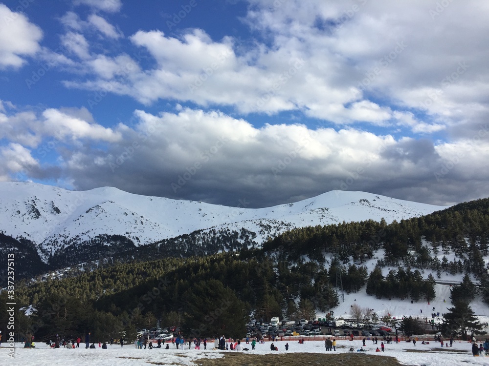 people on snow covered mountains against sky