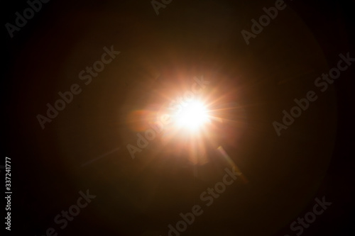 Abstract Natural Sun flare on the black background.