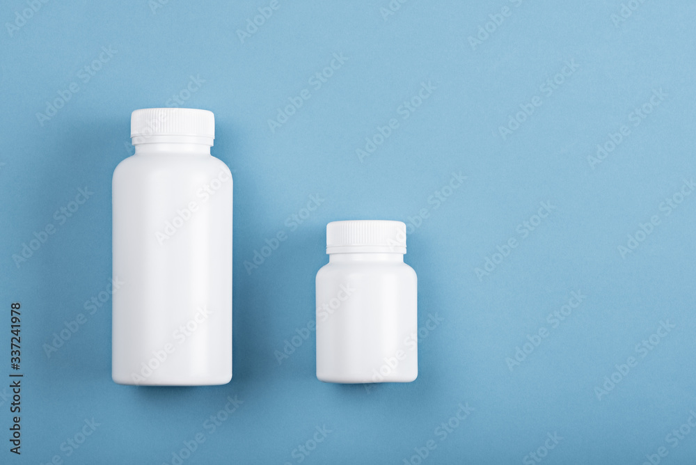 top view two plastic white bottles on blue background top view two plastic white bottles on blue background