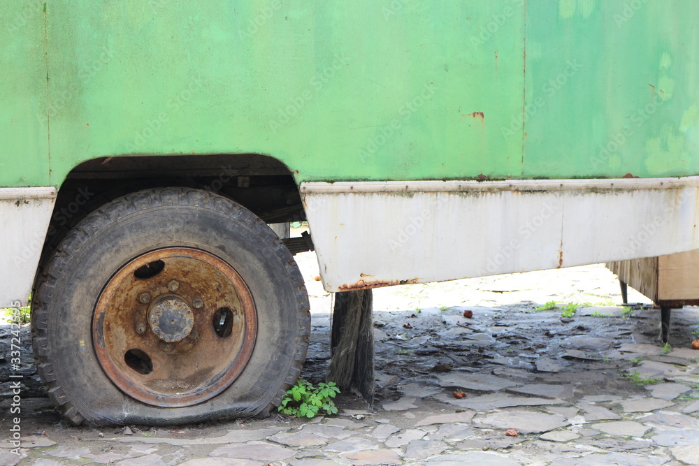 Flat tyre on green vehicle