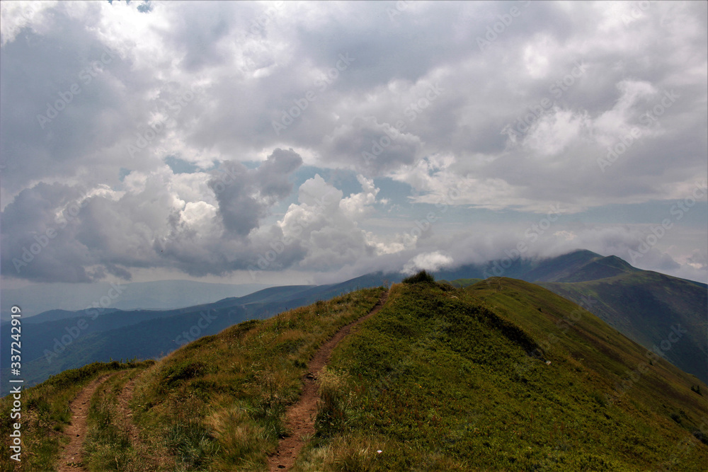 Fototapeta premium The road trough the mountains to the sky.