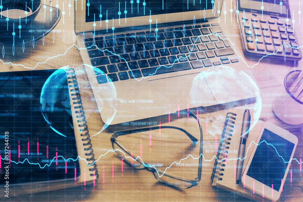 Double exposure of chart and financial info and work space with computer background. Concept of international online trading. Double exposure of chart and financial info and work space with computer background. Concept of international online trading.