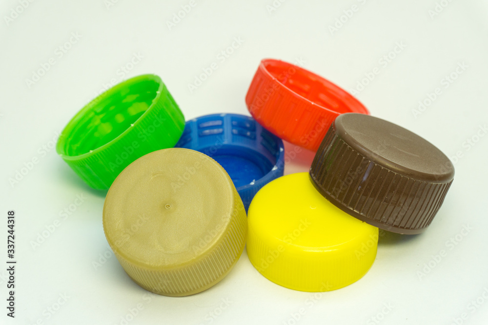 colorful plastic bottle stoppers on a white background colorful plastic bottle stoppers on a white background