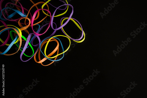 Colorful Rubber Bands Isolated on a Black Background. Minimalist concept. Background