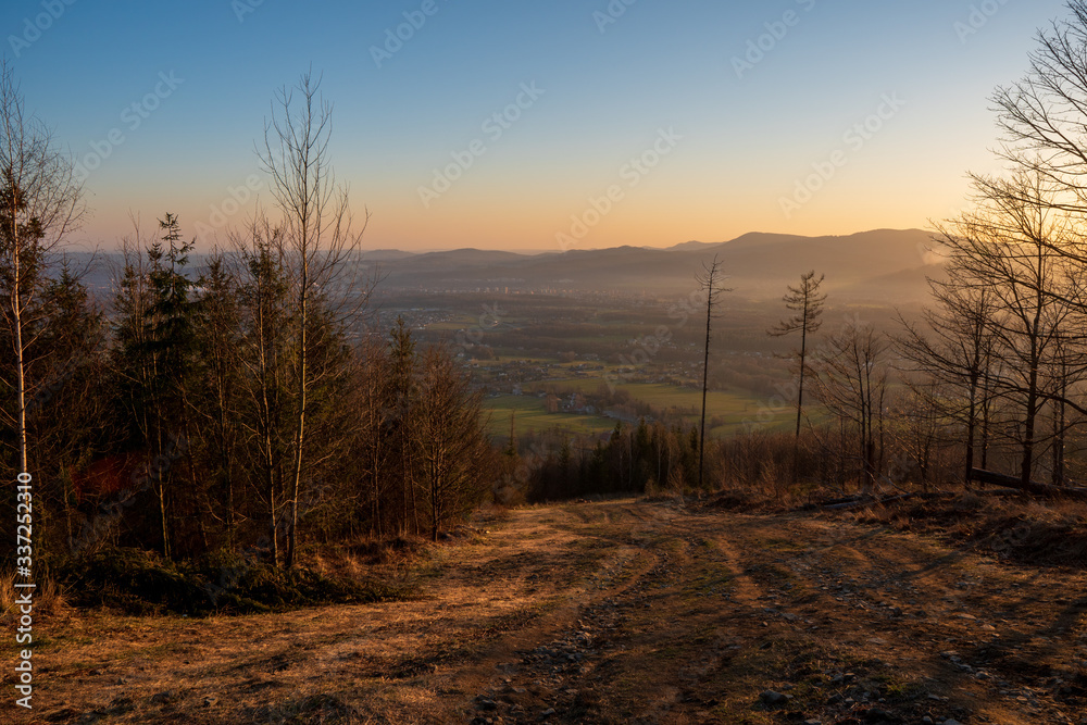 view of valley from hill at sunrise, houses and fields in countryside at sunrise, czech Beskydy Trinec view of valley from hill at sunrise, houses and fields in countryside at sunrise, czech Beskydy Trinec
