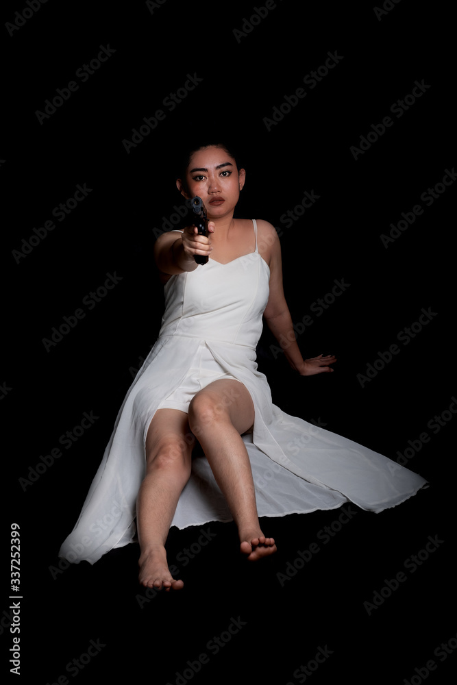 Portrait beautiful Asia woman one hand holding gun at the black