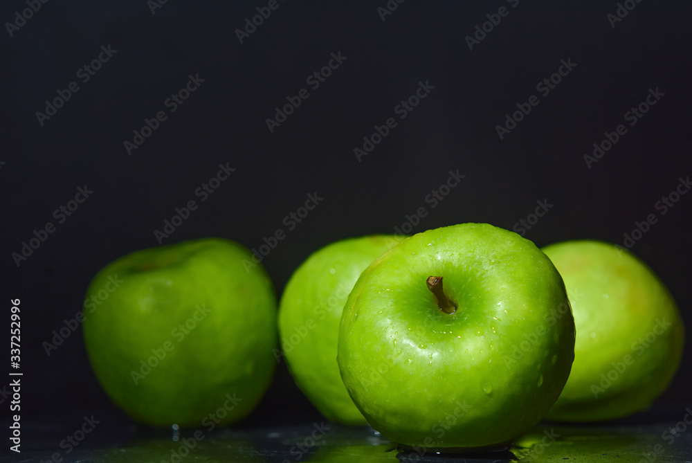 ripe green apples are covered with water drops ripe green apples are covered with water drops
