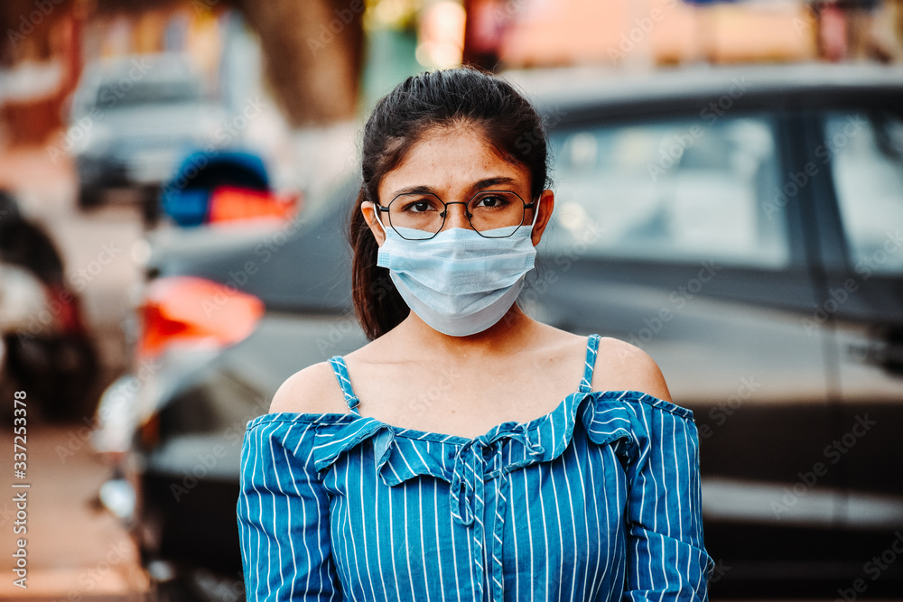 Portrait of an Indian female wearing medical mask to prevent herself from the Corona Virus Pandemic	