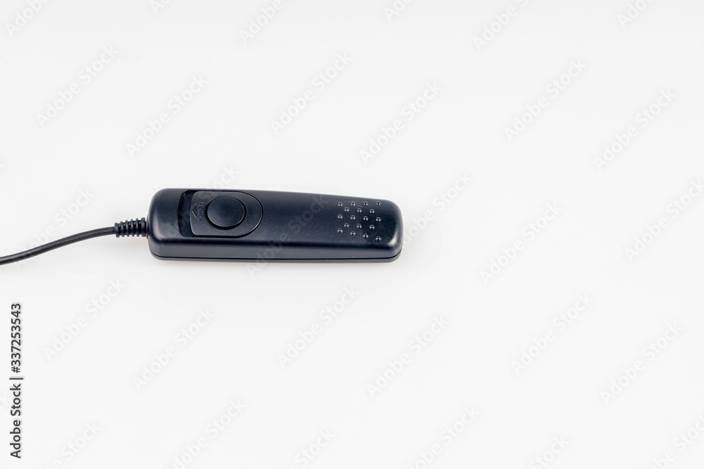 Camera cable remote switch control isolated on white background. Remote control shutter switch of DSLR camera. Remote camera shutter release on white background. Camera cable remote switch control isolated on white background. Remote control shutter switch of DSLR camera. Remote camera shutter release on white background.