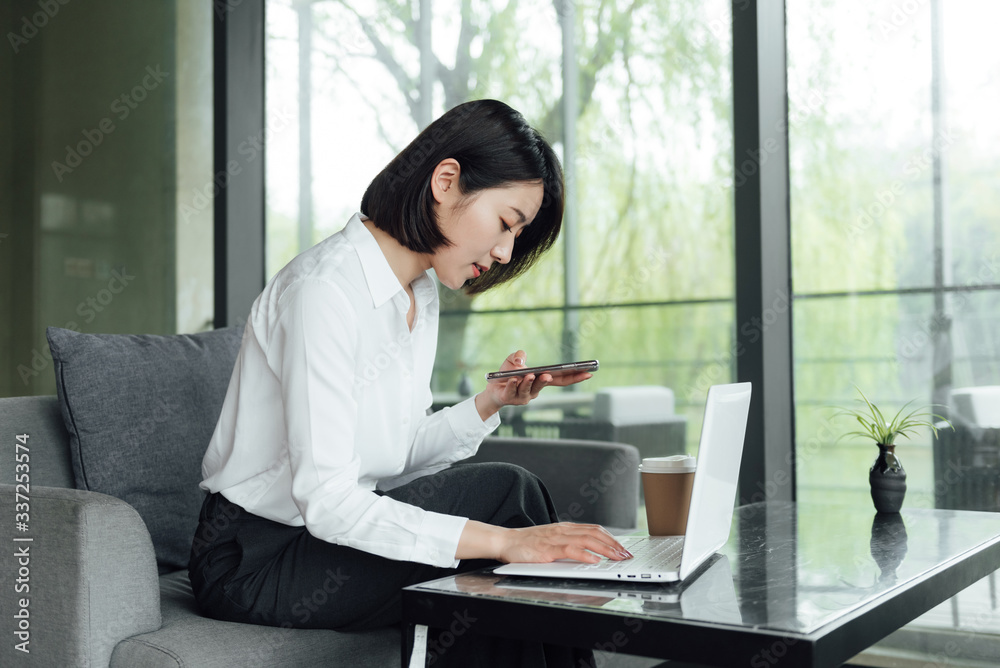 An Asian business woman with short hair is working An Asian business woman with short hair is working