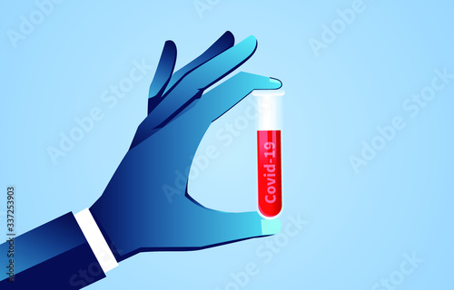Hand holding medical test tube of Coronavirus Covid-19