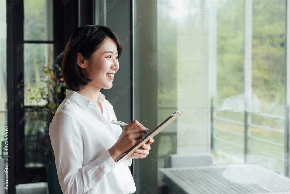 An Asian business woman with short hair is working An Asian business woman with short hair is working