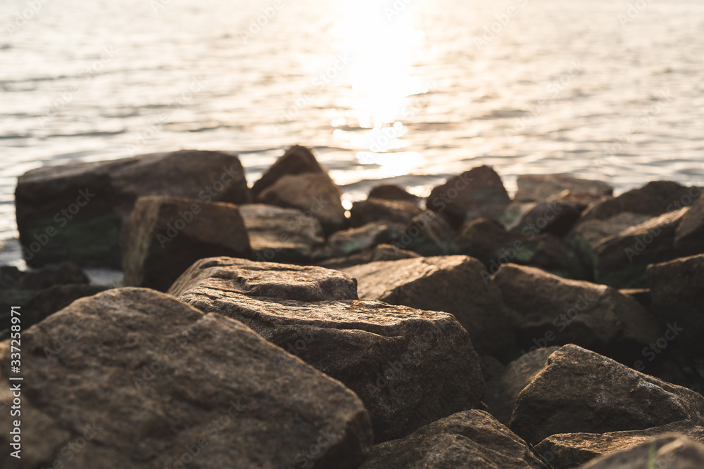 Obraz premium the morning light falls on the stones on the river bank