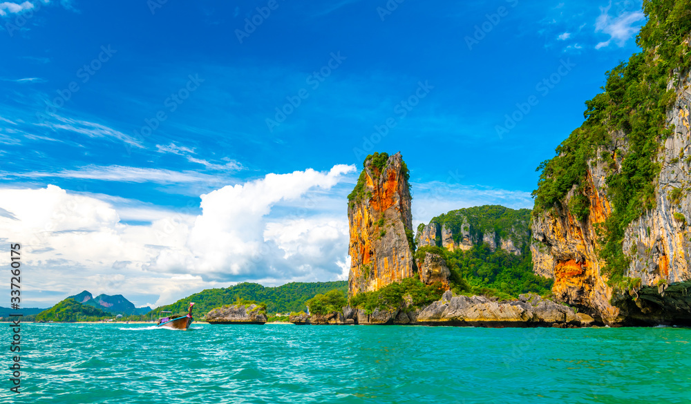 View from boat going to famous Railay beach in Krabi town, Thailand. Favorite place in Thailand with pure sea, white sand and beautiful limestone rocks. Vacation target in tropical paradise. View from boat going to famous Railay beach in Krabi town, Thailand. Favorite place in Thailand with pure sea, white sand and beautiful limestone rocks. Vacation target in tropical paradise.