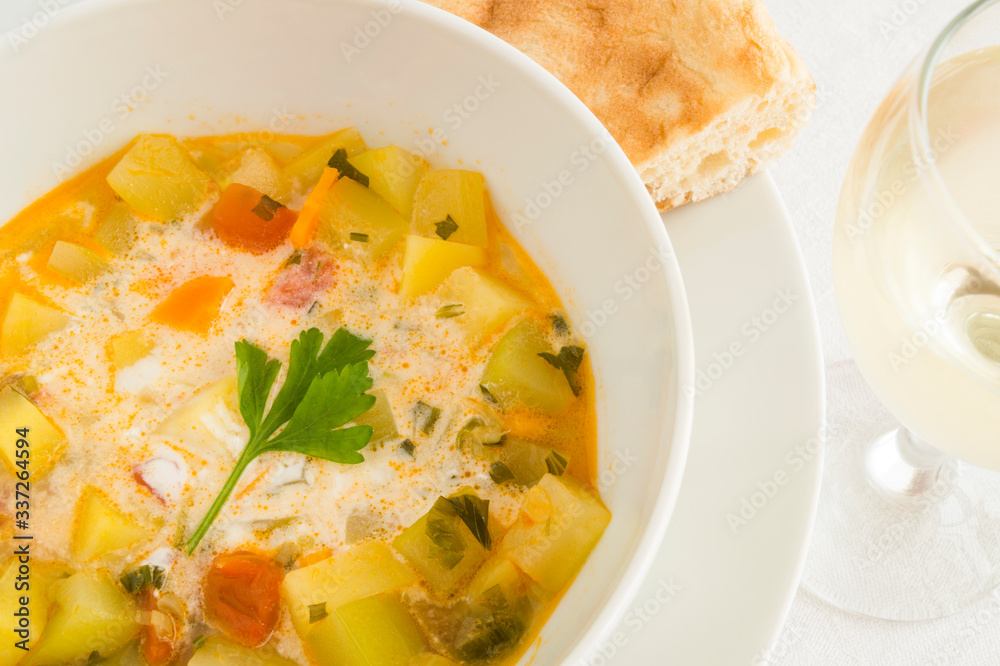 vegetable soup with sour cream served with pita and white wine vegetable soup with sour cream served with pita and white wine