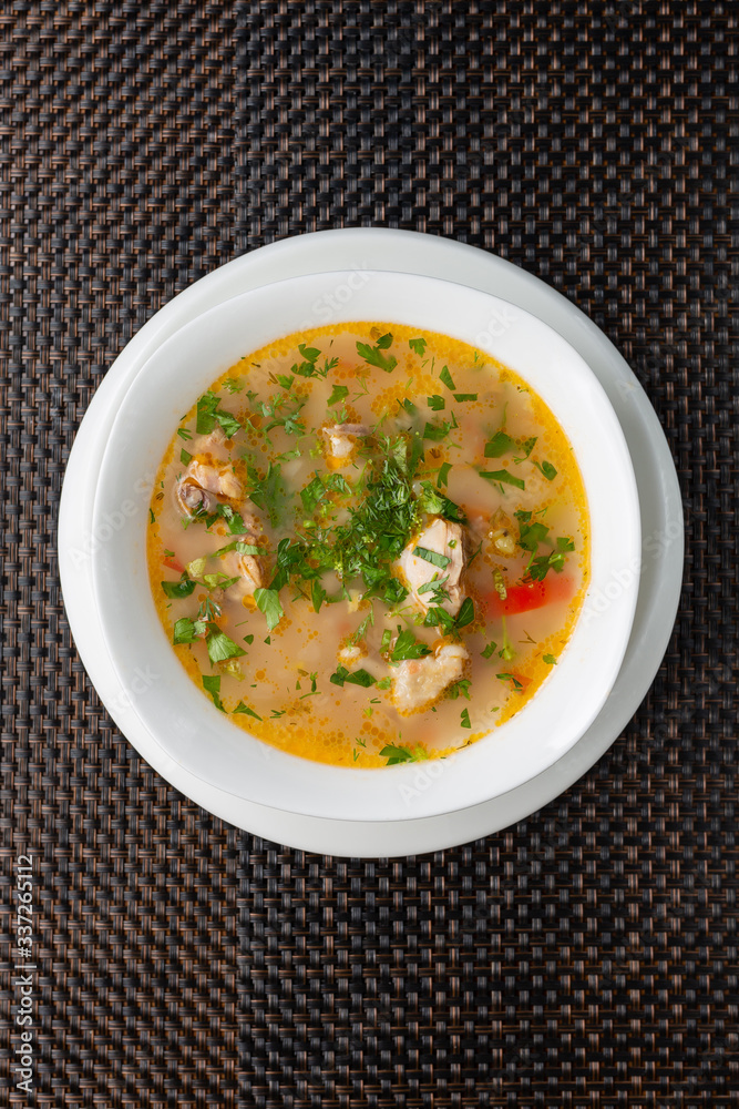 chicken soup on a broth with vegetables in a white bowl chicken soup on a broth with vegetables in a white bowl