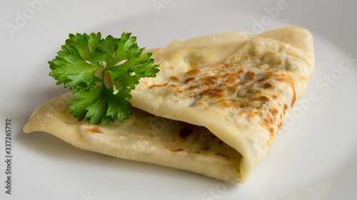 gözleme bend in half decorated with parsley 