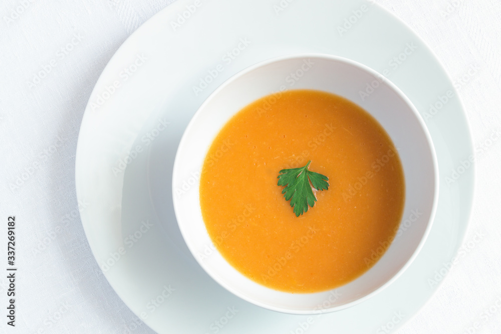 pumpkin soup puree decorated with parsley leaf pumpkin soup puree decorated with parsley leaf