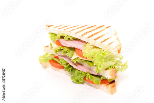 sandwich- grilled toast with lettuce, tomato and ham isolated on white background