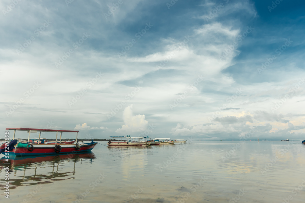 Seascape. Boats on calm water, landscape background clouds.
