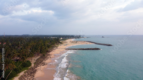 Beautiful beach with blue water and palm on Sri Lanka