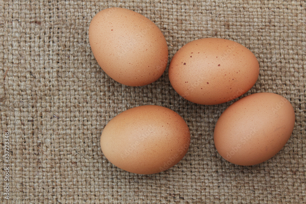 Fresh chicken eggs on burlap sack,top view Fresh chicken eggs on burlap sack,top view