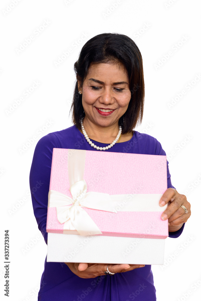 Studio shot of happy mature Asian woman opening gift box isolated against white background Studio shot of happy mature Asian woman opening gift box isolated against white background