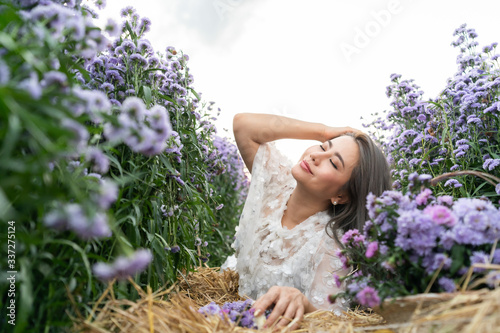 Portrait of beautiful romantic woman in fairy field of Margaret with bouquet.