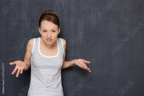 Portrait of dissatisfied indignant blond girl rebuking somebody