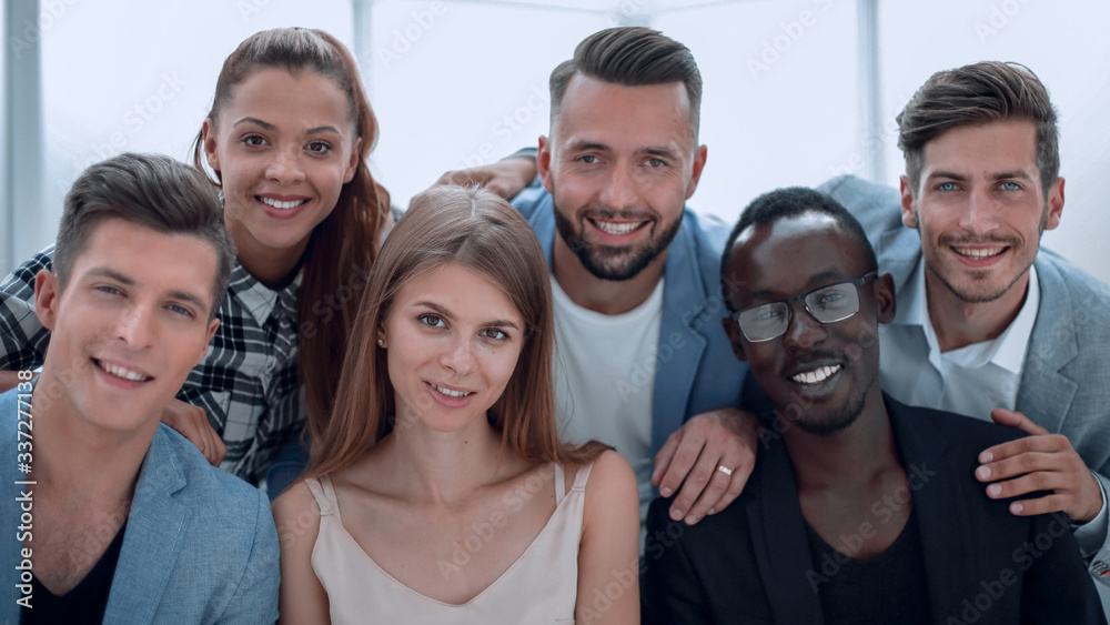 Group of young executives smiling at camera during a work meeting. Group of young executives smiling at camera during a work meeting.