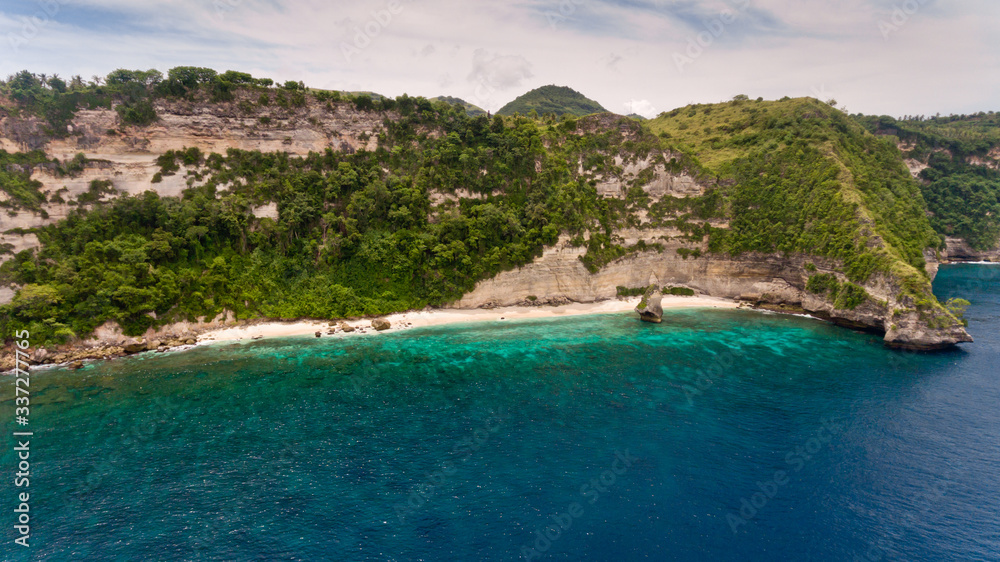 Aerial view on Pura Temple on hardly accessible deserted Suwehan beach. Nusa Penida paradise Island, Indonesia.