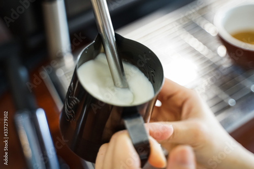Barista steam milk ,making coffee at caffe