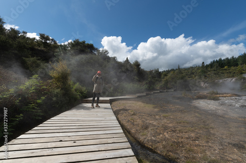 Young photographer photographing at Orakei Korako Geothermal, New Zealand.