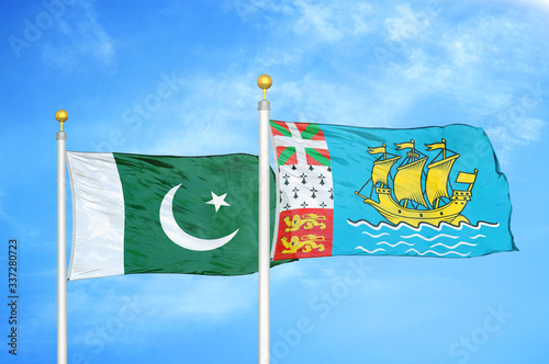 Pakistan and Saint Pierre and Miquelon two flags on flagpoles and blue cloudy sky photo