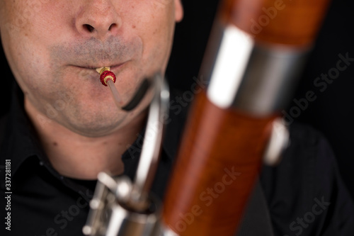 Wooden bassoon isolated on a black background. Musical instruments. Musician playing the instrument. photo