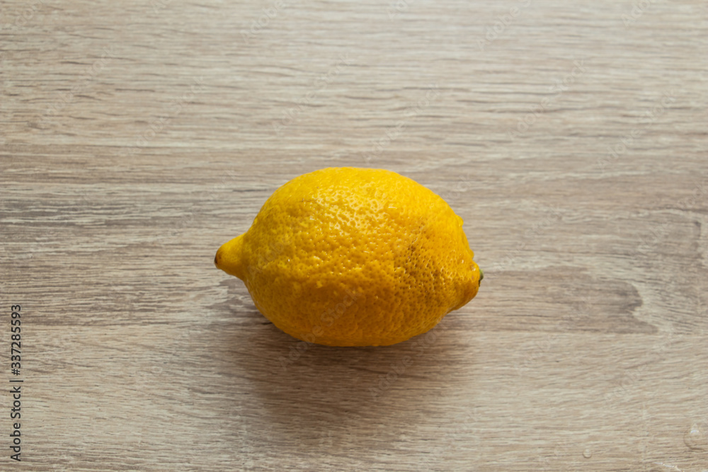 lemon on a wooden background in the center of the frame close-up