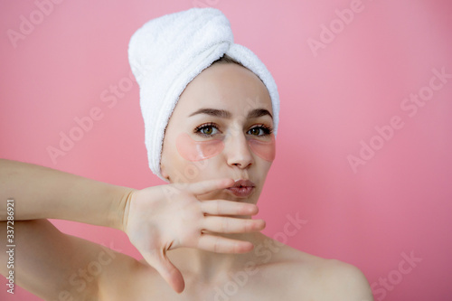 Portrait of Beauty Woman with Eye Patches on pink background. Woman Beauty Face with Mask under Eyes. Skin care, cosmetic product concept