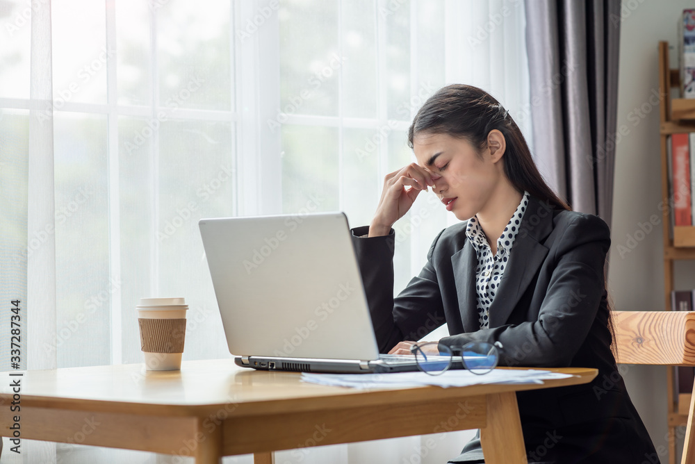 Stressed business Asian woman with palm on face in her office Stressed business Asian woman with palm on face in her office