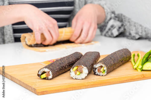 Sushi roll Japanese food preparing maki roles by hand